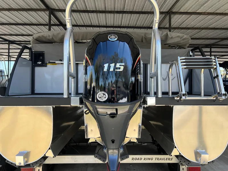 Slide: The Image of 2025 JC 201 Spirit TT Sport boat with 115 HP outboard motor, parked on Road King trailer. - 7