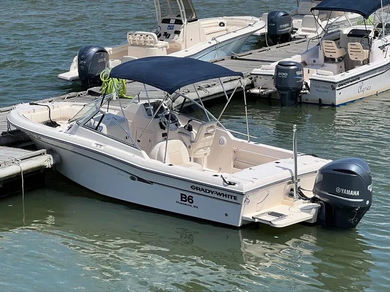 Slide: The Image of 2010 Grady-White Tournament 225 boat docked with Yamaha outboard motor. - 2