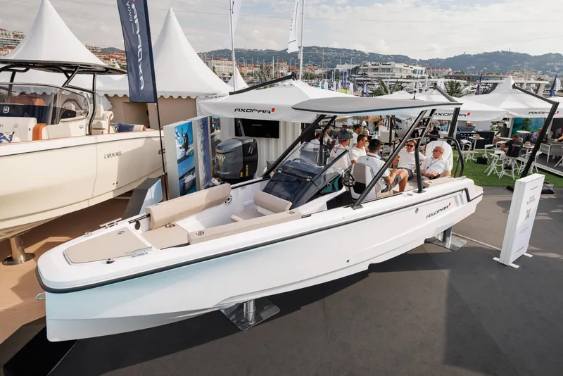 Slide: The Image of 2025 Axopar 22 T-Top Mediterrana boat displayed at a marine exhibition. - 4
