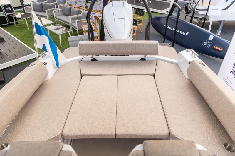 Slide: The Image of 2025 Axopar 22 T-Top Mediterrana boat interior with beige seating and Finnish flag. - 6