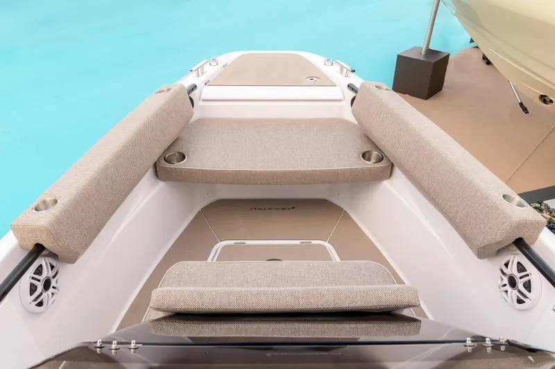 Slide: The Image of 2025 Axopar 22 T-Top Mediterrana boat interior with beige seating and cup holders. - 7