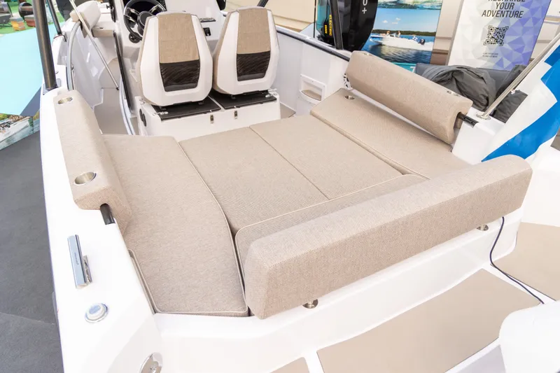 Slide: The Image of 2025 Axopar 22 T-Top Mediterrana boat interior with beige seating and modern design. - 8