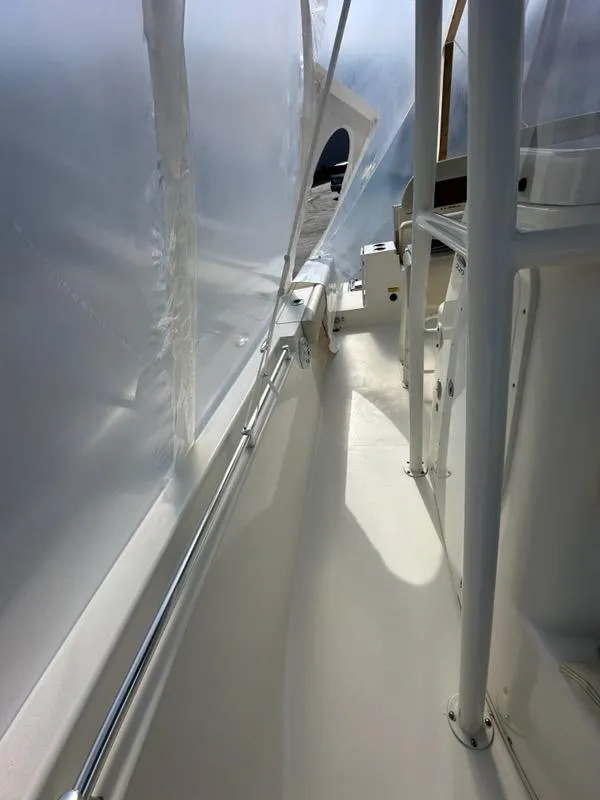 Slide: The Image of 2023 Cobia 220 Center Console boat interior with protective covering. - 13