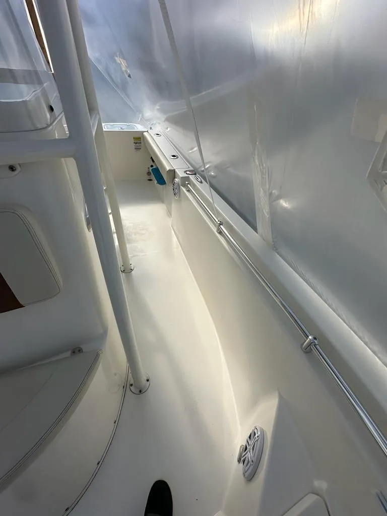 Slide: The Image of 2023 Cobia 220 Center Console boat interior with white deck and railing. - 14