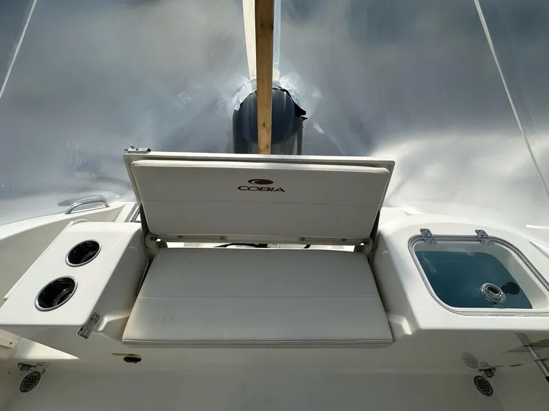 Slide: The Image of 2023 Cobia 220 Center Console boat interior with seating and storage. - 17
