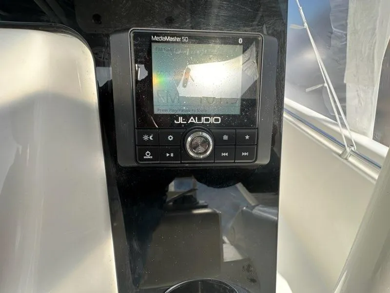 Slide: The Image of JL Audio MediaMaster 50 on 2023 Cobia 220 Center Console boat dashboard. - 5