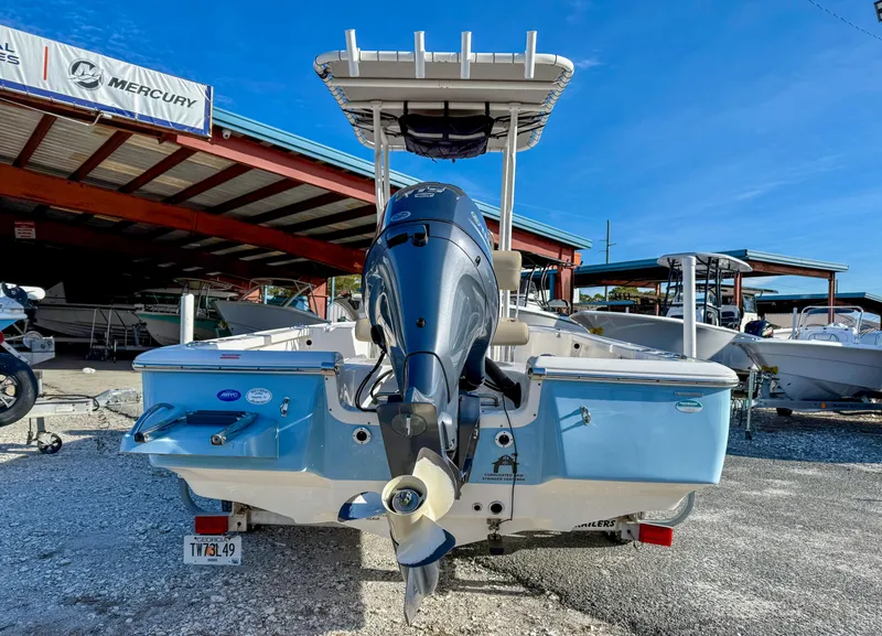 Slide: The Image of 2018 Tidewater 1910 Bay Max boat with outboard motor, displayed at a dealership. - 14