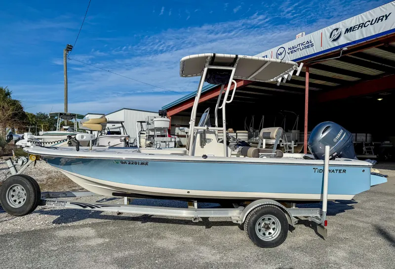 Slide: The Image of 2018 Tidewater 1910 Bay Max boat on trailer, parked outside a dealership. - 2