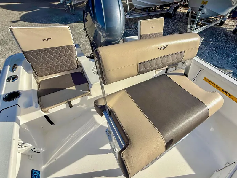 Slide: The Image of 2018 Tidewater 1910 Bay Max boat interior with cushioned seating and motor. - 6