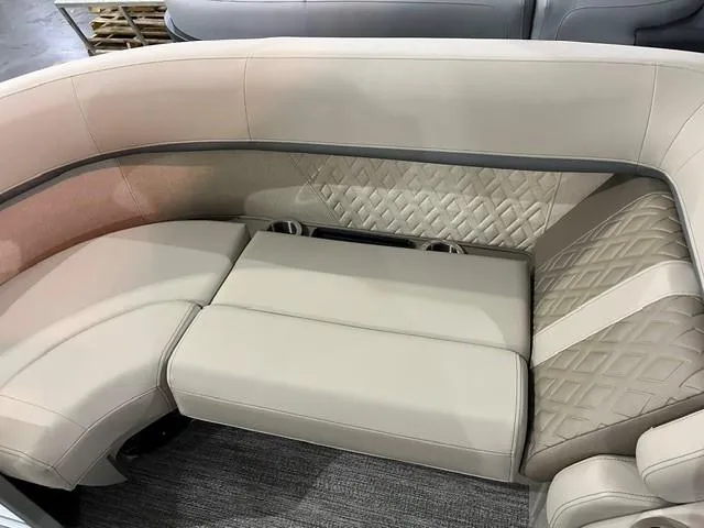 Slide: The Image of 2025 Bennington M22 Swingback interior with beige quilted seating and modern design. - 4