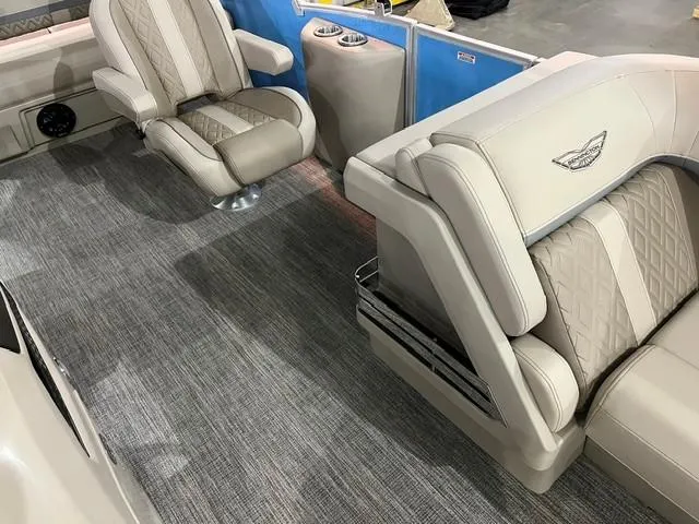 Slide: The Image of 2025 Bennington M22 Swingback interior with beige seating and carpeted flooring. - 5