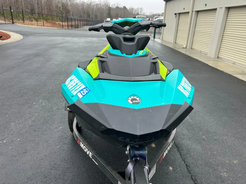Slide: The Image of 2022 Sea-Doo Spark 2 UP jet ski in vibrant teal, parked on asphalt. - 3