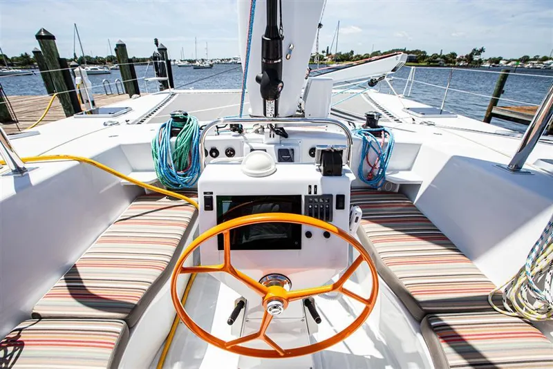 Slide: The Image of Cockpit of 2018 Chris White Atlantic 49 MastFoil sailboat with striped seating and orange wheel. - 5