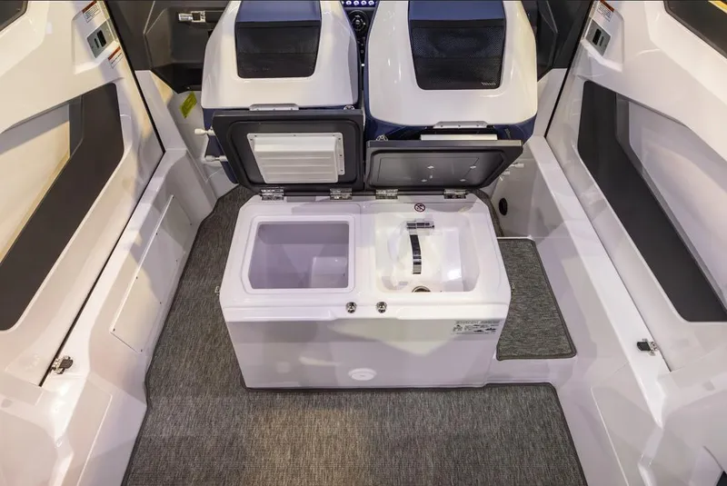 Slide: The Image of 2025 Axopar 29 XC Cross Cabin interior with storage compartments and carpeted flooring. - 9