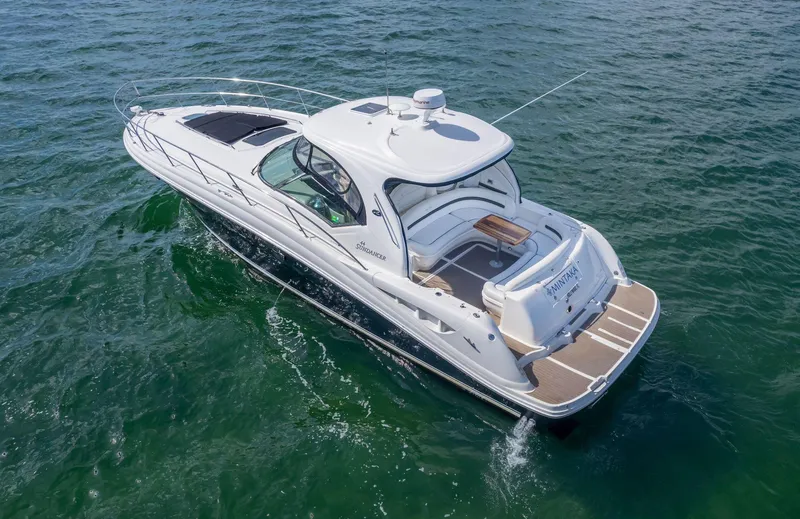 Slide: The Image of 2007 Sea Ray 44 Sundancer yacht cruising on open water, showcasing sleek design and luxury features. - 1