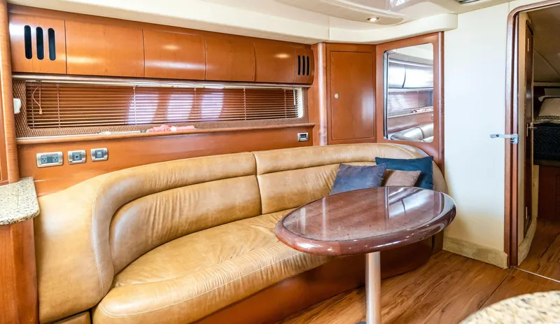 Slide: The Image of Interior of 2007 Sea Ray 44 Sundancer yacht with leather seating and wooden table. - 11
