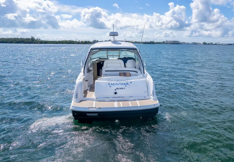 Slide: The Image of 2007 Sea Ray 44 Sundancer yacht on open water under a partly cloudy sky. - 4