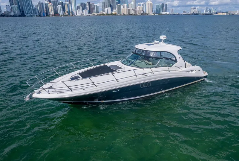 Slide: The Image of 2007 Sea Ray 44 Sundancer yacht cruising near city skyline. - 5