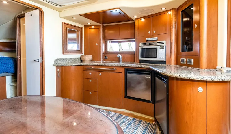 Slide: The Image of Luxurious interior of 2007 Sea Ray 44 Sundancer yacht with modern kitchen amenities. - 7