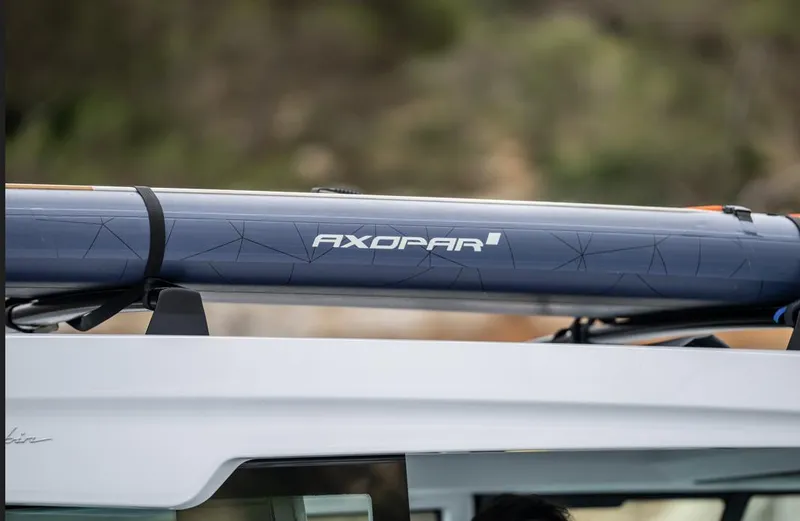 Slide: The Image of 2025 Axopar 29 XC Cross Cabin boat interior with cushioned seating and modern design. - 4