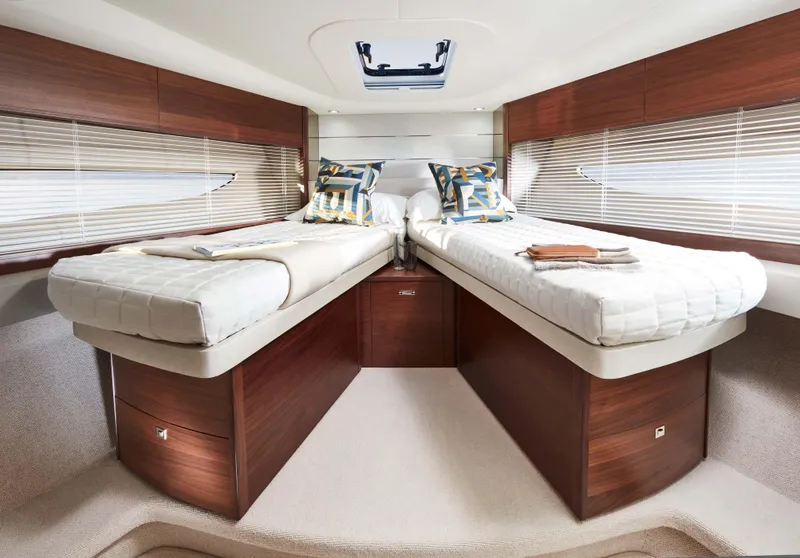 Slide: The Image of Interior of 2026 Princess V50 Deck yacht with twin beds and modern decor. - 10