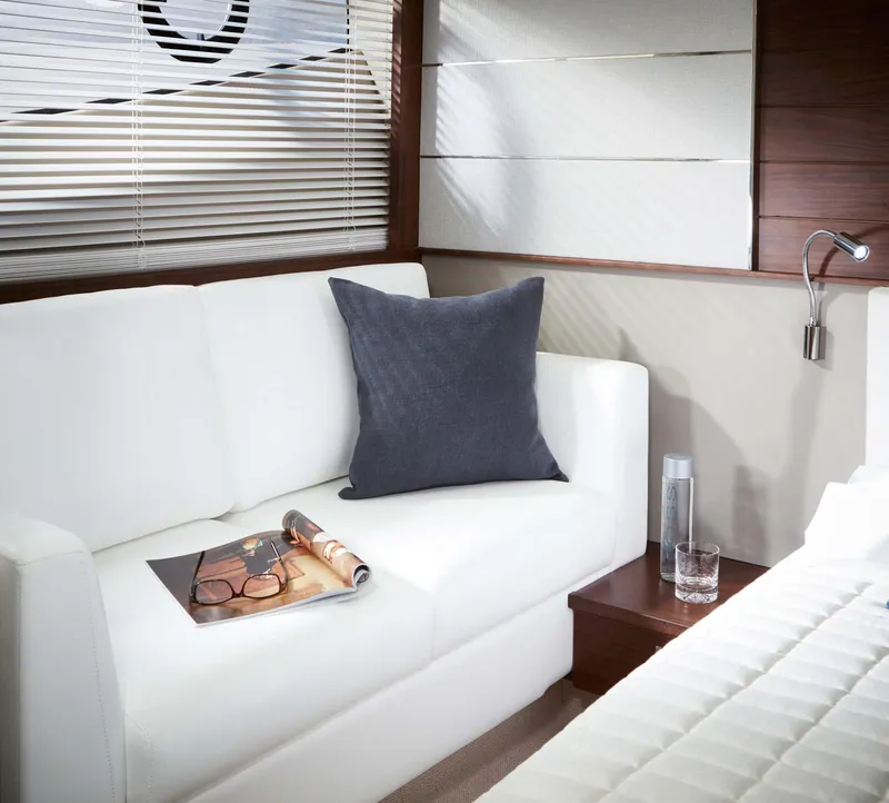 Slide: The Image of Luxurious interior of 2026 Princess V50 Deck yacht with white sofa and modern decor. - 13