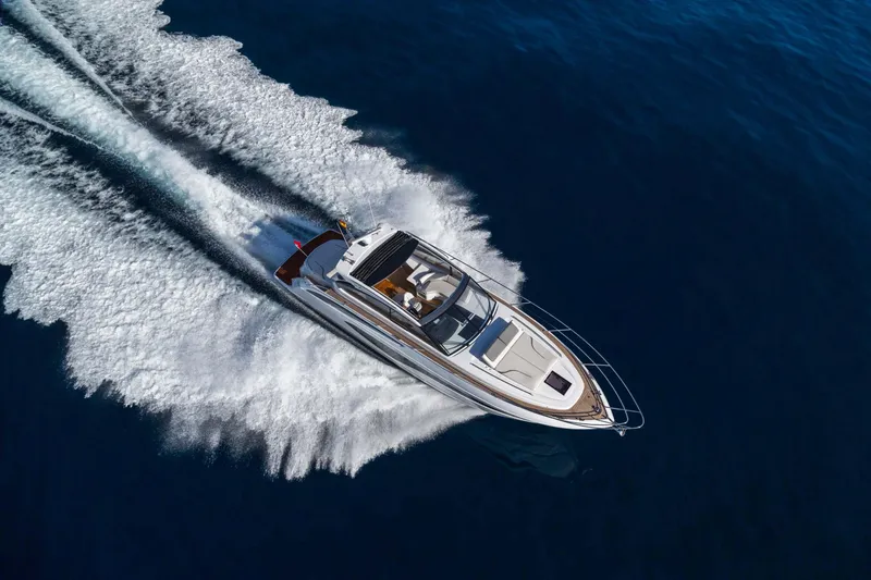 Slide: The Image of 2026 Princess V50 Deck yacht cruising on open water, aerial view. - 15
