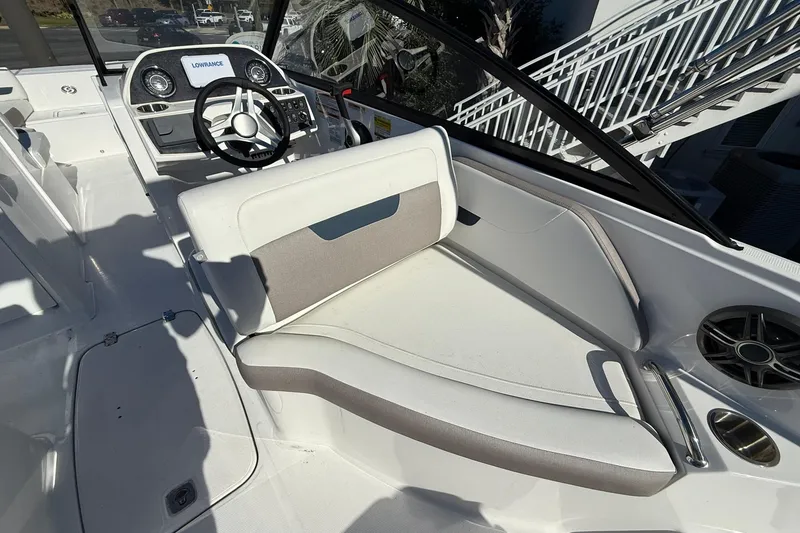 Slide: The Image of 2025 Hurricane SunDeck 235 OB boat interior with steering wheel and seating area. - 13