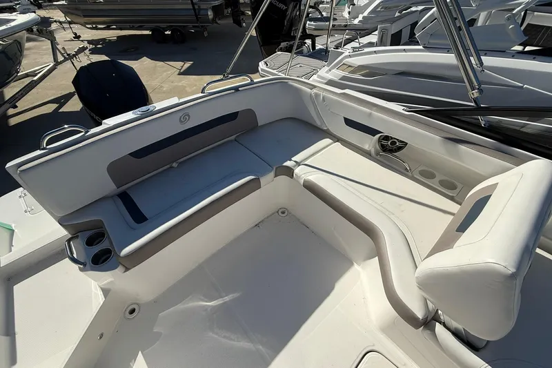 Slide: The Image of 2025 Hurricane SunDeck 235 OB boat interior with white seating and cup holders. - 14