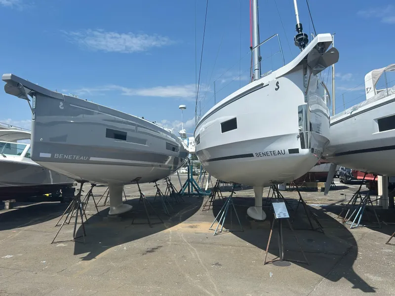 Slide: The Image of 2025 Beneteau Oceanis 40.1 sailboats on stands, displayed outdoors under a clear sky. - 2