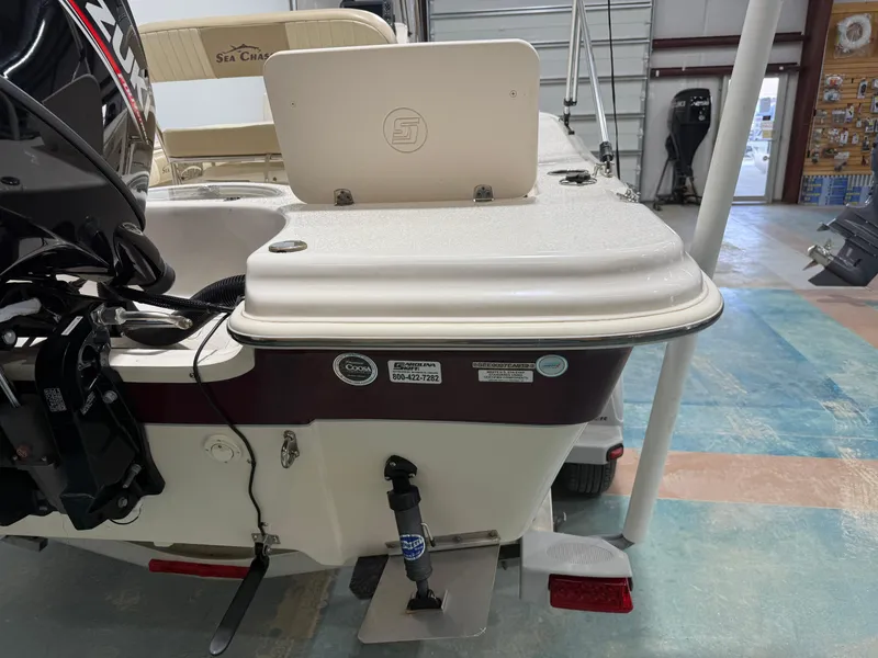 Slide: The Image of 2019 Carolina Skiff 19 Sea Chaser boat with Suzuki outboard motor in a showroom. - 12