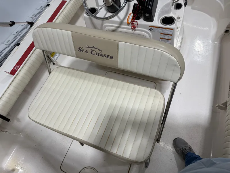 Slide: The Image of 2019 Carolina Skiff 19 Sea Chaser boat interior with white seating and steering console. - 16
