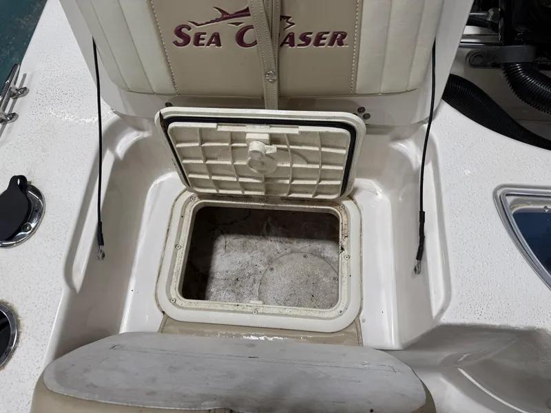 Slide: The Image of 2019 Carolina Skiff 19 Sea Chaser boat storage compartment open, showcasing interior details. - 18