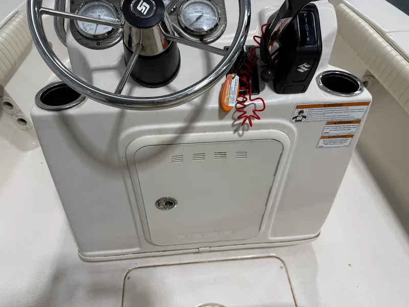 Slide: The Image of 2019 Carolina Skiff 19 Sea Chaser console with steering wheel and controls. - 19