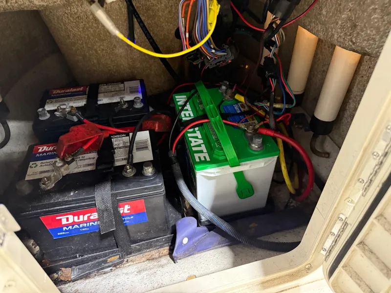 Slide: The Image of Batteries and wiring inside a 2019 Carolina Skiff 19 Sea Chaser boat compartment. - 23