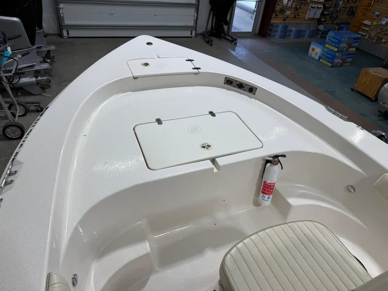 Slide: The Image of 2019 Carolina Skiff 19 Sea Chaser boat interior with storage compartments and fire extinguisher. - 25