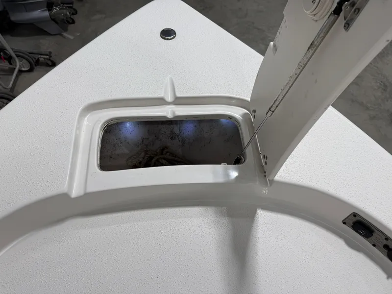 Slide: The Image of 2019 Carolina Skiff 19 Sea Chaser anchor locker with open hatch and visible rope. - 26