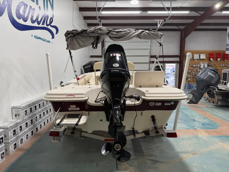 Slide: The Image of 2019 Carolina Skiff 19 Sea Chaser boat in showroom, rear view with outboard motor. - 5
