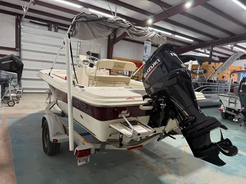 Slide: The Image of 2019 Carolina Skiff 19 Sea Chaser boat with Suzuki outboard motor in a garage. - 6