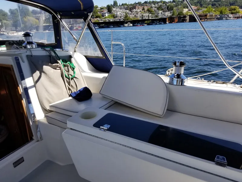 Slide: The Image of 2004 Catalina 42 MkII sailboat cockpit with seating, overlooking a scenic waterfront. - 18
