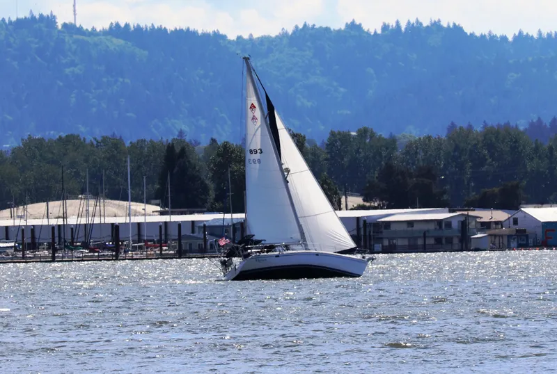 Slide: The Image of Sailboat Catalina 42 MkII 2004 on a scenic lake with forested hills in the background. - 24