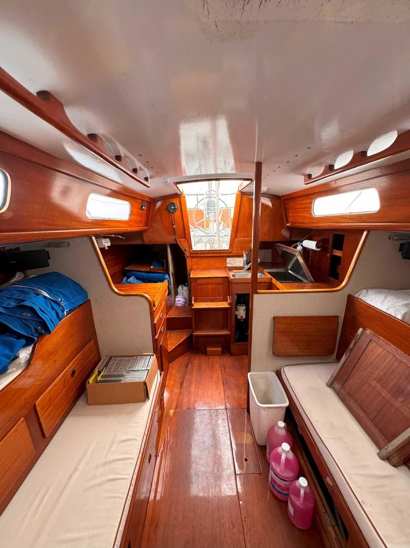 Slide: The Image of Interior of a 1969 Ohlson 38 sailboat with wooden finishes and cozy seating. - 11