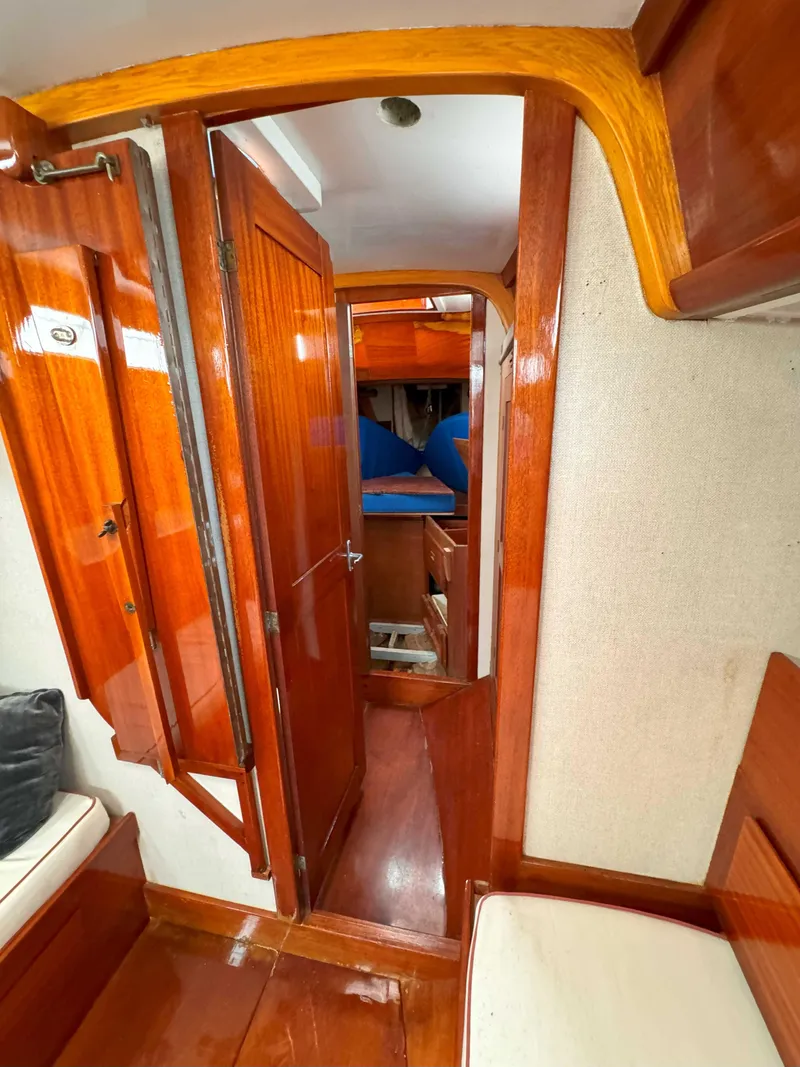 Slide: The Image of Interior view of a 1969 Ohlson 38 sailboat, featuring polished wood finishes and cozy cabin space. - 12