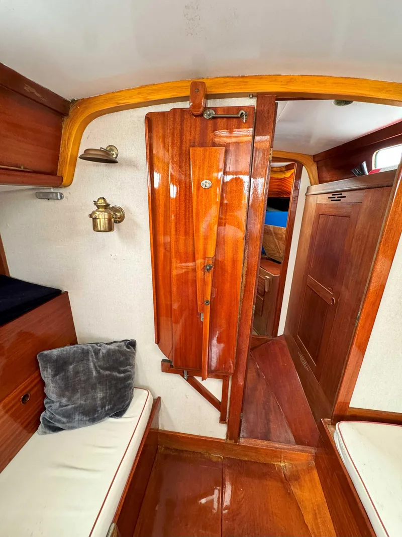 Slide: The Image of Interior of a 1969 Ohlson 38 sailboat with polished wood and cozy seating. - 14