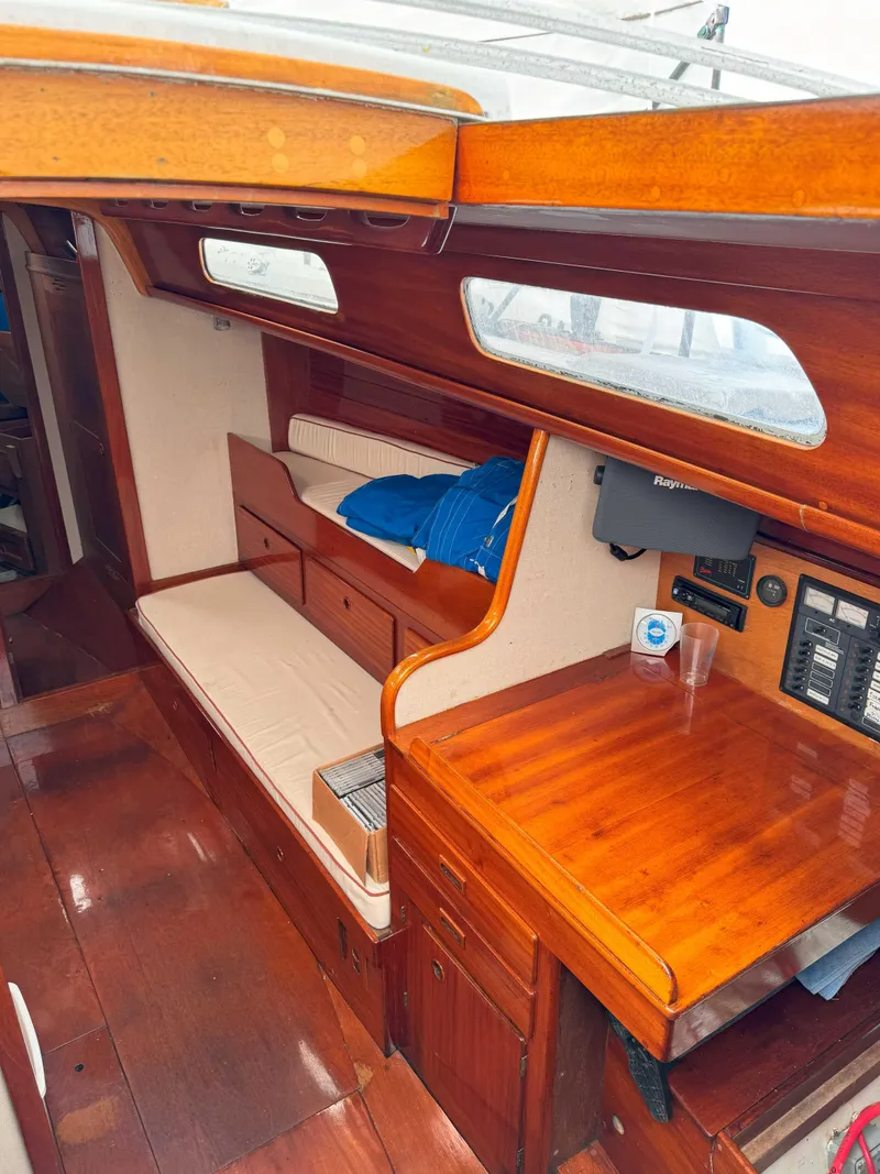 Slide: The Image of 1969 Ohlson 38 yacht interior with wooden finish and seating area. - 15