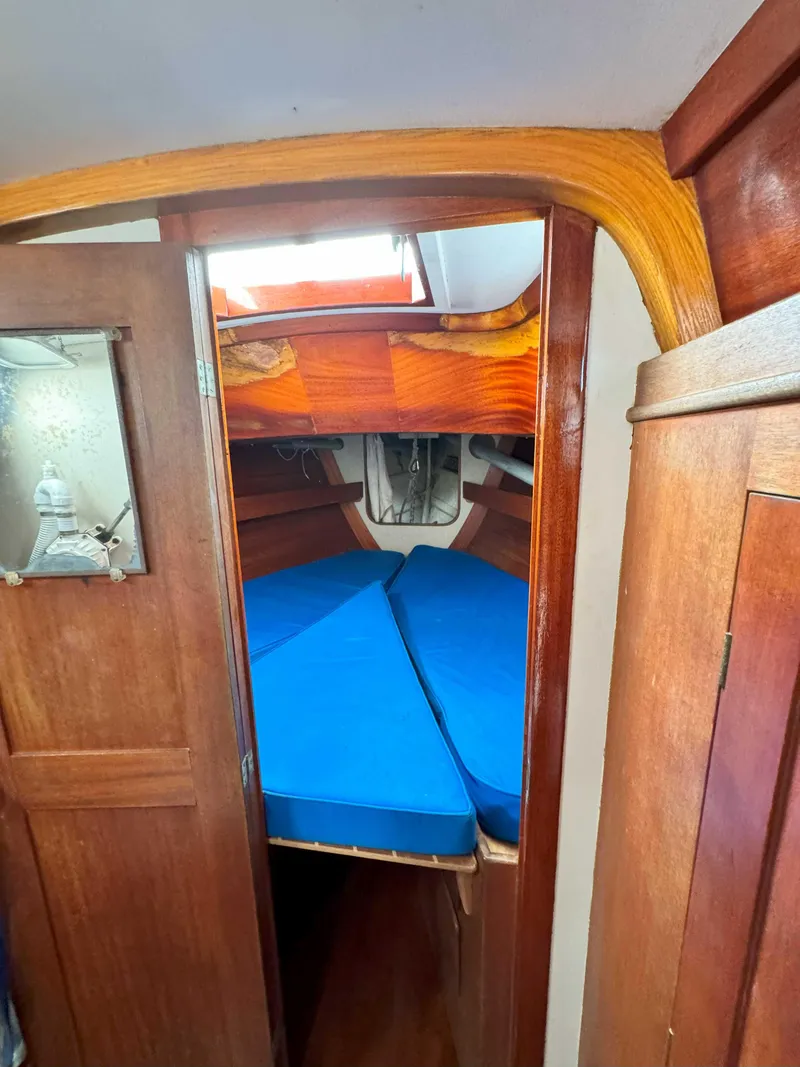 Slide: The Image of Interior of a 1969 Ohlson 38 sailboat with blue cushions and wooden finish. - 20