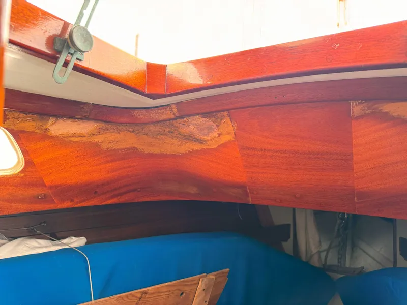 Slide: The Image of Interior of a 1969 Ohlson 38 sailboat with polished wood and blue upholstery. - 21