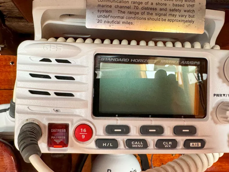 Slide: The Image of VHF marine radio on 1969 Ohlson 38 sailboat, featuring distress button and channel controls. - 25