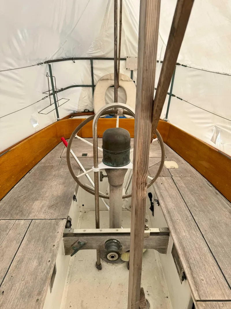 Slide: The Image of 1969 Ohlson 38 sailboat cockpit with wooden benches and steering wheel. - 5