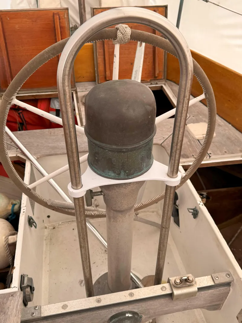 Slide: The Image of Steering wheel of a 1969 Ohlson 38 sailboat, featuring a classic nautical design. - 6